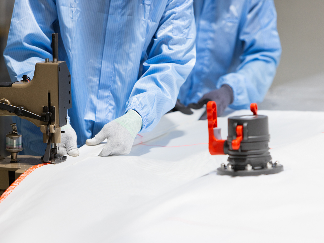 Man stitching a flexitank